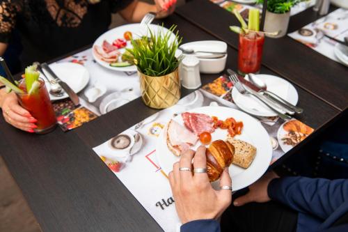 a table topped with plates filled with food at The Exhibitionist Hotel in London