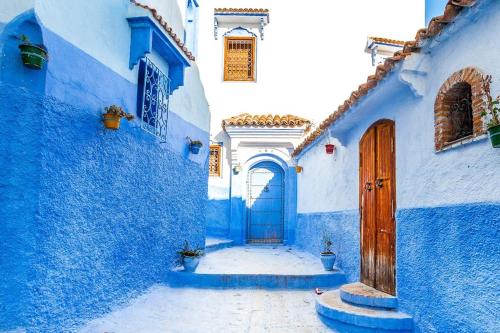 a group of blue buildings with a blue door at CASA dreams Chaouen in Chefchaouene