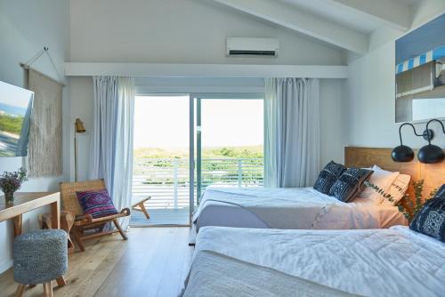 Postel nebo postele na pokoji v ubytování Hero Beach Club