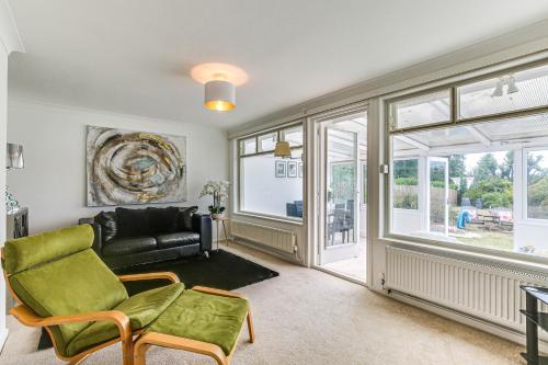 a living room with a couch and a window at LOCHIEL in Tatsfield