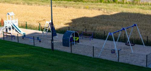 a playground with a bunch of slides and swings at Apartamenty Termalne Dobry Klimat in Uniejow