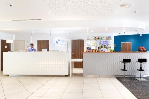 a man standing at a counter in a kitchen at Holiday Inn Express Toulon - Est by IHG in Toulon