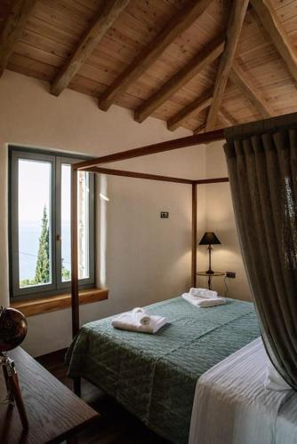 a bedroom with a bed with two towels on it at Archontiko Epirus 2 in Mouresi