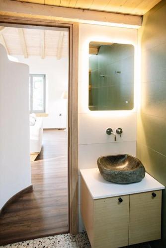 a bathroom with a sink on top of a counter at Archontiko Epirus 2 in Mouresi