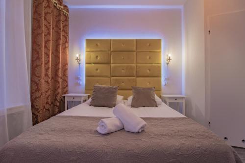 a bedroom with a bed with two white pillows on it at Wrzos & Belvedere in Kudowa-Zdrój