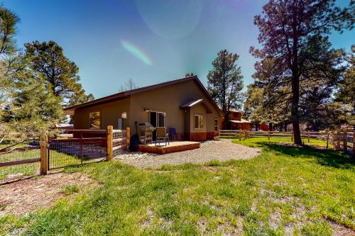 a house with a fence and a yard at Quartz Court in Pagosa Springs