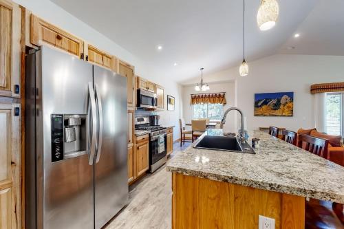 a kitchen with a stainless steel refrigerator at Quartz Court in Pagosa Springs