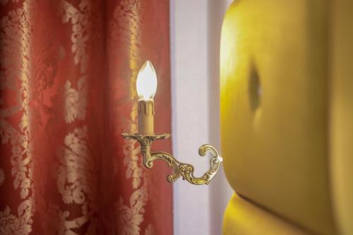 a candle in a room next to a window at Wrzos & Belvedere in Kudowa-Zdrój