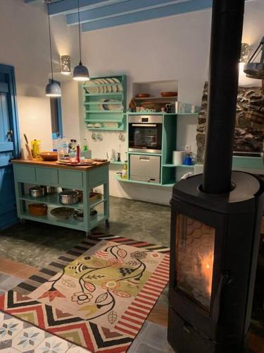 a kitchen with a wood stove in a room at Traumhaus Nisyros in Páloi