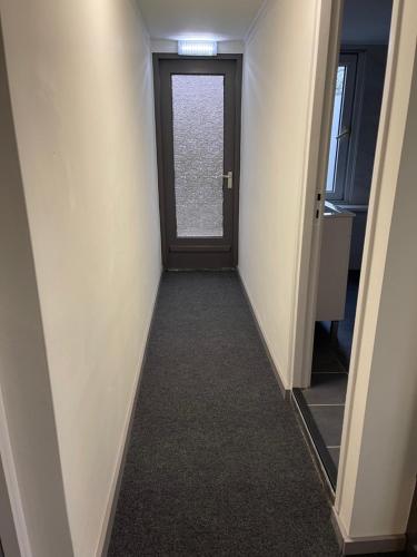 a hallway with a door in a room at Hotel B&B Sint-Maria NEXT DOOR in Valkenburg