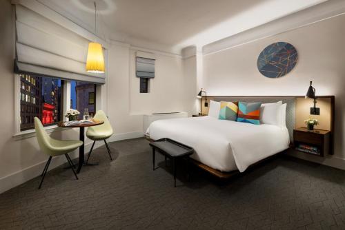 a hotel room with a large bed and a desk at Hotel Seville NoMad - The Unbound Collection by Hyatt in New York