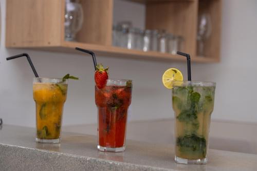 a group of three cocktails sitting on a counter at Nivial in Tacna