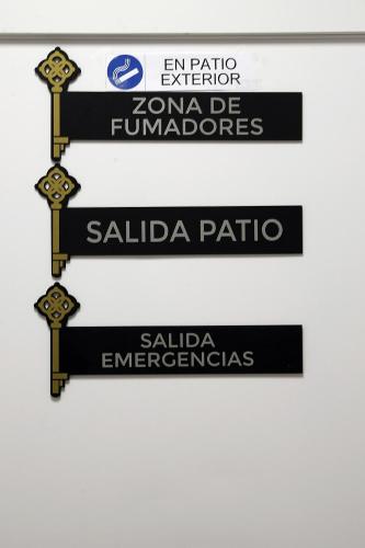 a group of street signs on a wall at Apartamentos Las trece llaves Jacuzzi bajo reserva in Merida