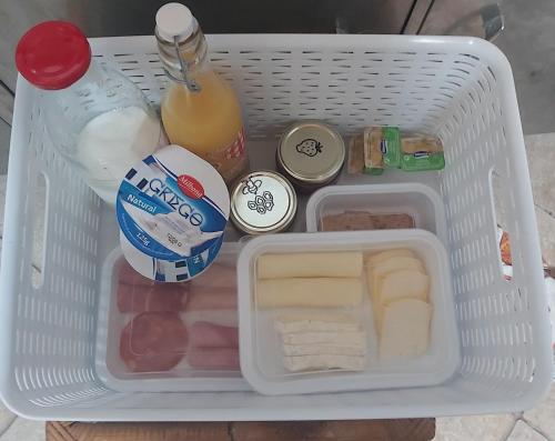 a white container filled with food in a refrigerator at Monte de Santo Antonio - Turismo Rural in Vila do Bispo