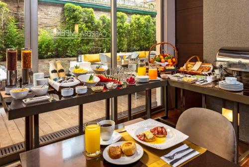 a breakfast buffet in a hotel with food on a table at Hotel Cabrera Imperial By key 33 in Bogotá