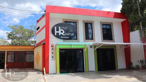 a building with a sign on the side of it at Hotel Boutique La Riviera in Rivera