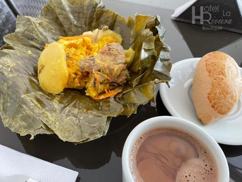 a plate of food with a sandwich and a cup of coffee at Hotel Boutique La Riviera in Rivera