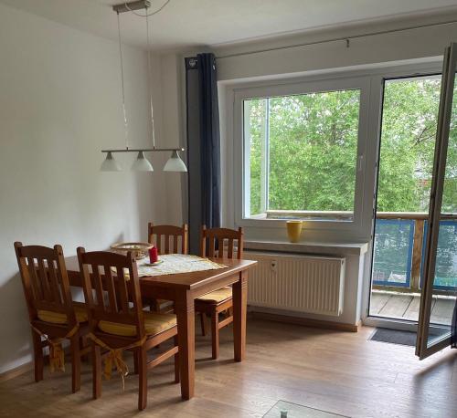 a dining room with a table and chairs and a window at Ferienwohnung Keilbergblick in Kurort Oberwiesenthal