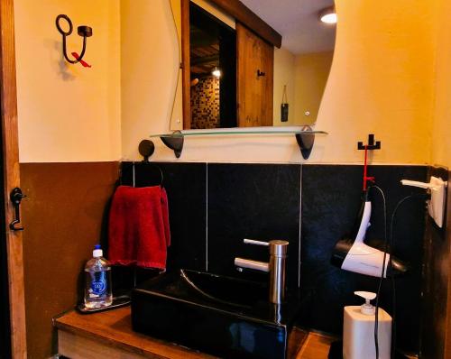 a bathroom with a black sink and a mirror at Pirts Rozēni in Saulkrasti