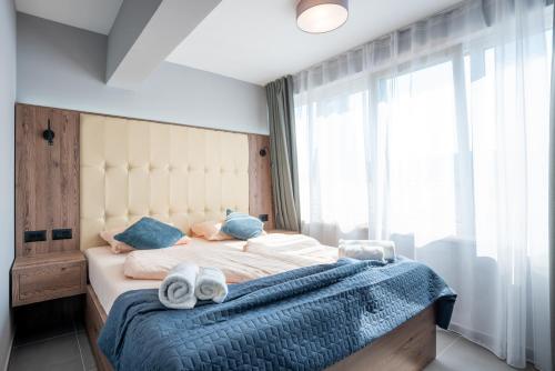 a bedroom with a large bed with towels on it at "Echo" B&B rooms, boutique beach hotel in Rabac