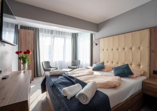 a bedroom with a large bed with blue pillows at "Echo" B&B rooms, boutique beach hotel in Rabac