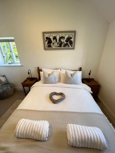 a bedroom with a bed with a heart decoration on it at The Old Parlour - With Hot tub and Dog Friendly! in Selby