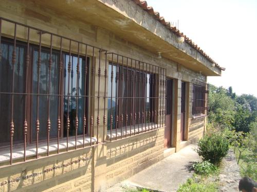a building with barred windows on the side of it at Posada Xamicalli in Tlayacapan