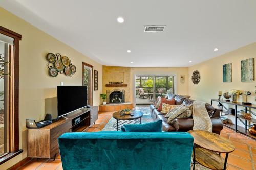 a living room with a blue couch and a tv at Canyon Palms in San Diego