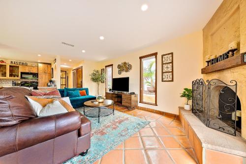 a living room with a leather couch and a fireplace at Canyon Palms in San Diego