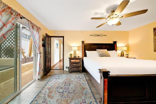 a bedroom with a bed and a ceiling fan at Canyon Palms in San Diego