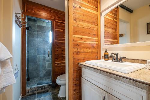 a bathroom with a sink and a toilet and a shower at Canyon Palms in San Diego