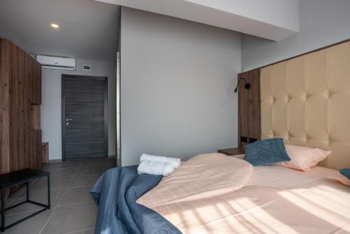 a bedroom with a large bed with a large headboard at "Echo" B&B rooms, boutique beach hotel in Rabac