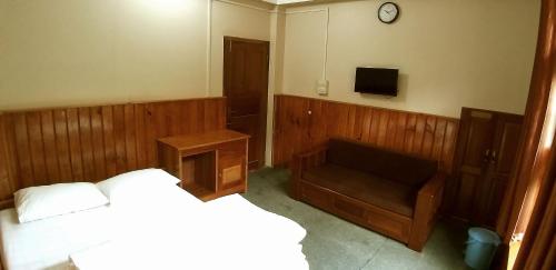 Ένα ή περισσότερα κρεβάτια σε δωμάτιο στο Kharjap Homestay