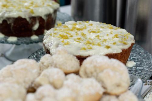 a plate with a cupcake and donuts on a table at Hotel Alfa de Bauru Ltda in Bauru