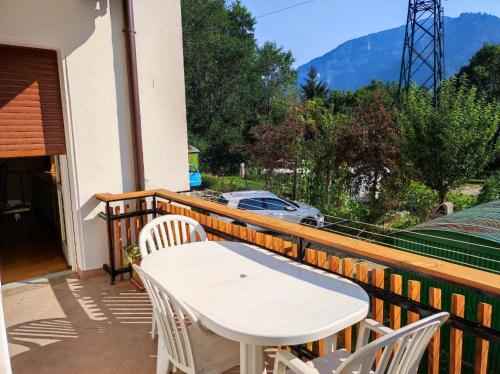 a white table and chairs on a balcony at Appartamento Vanoi nel cuore verde del Trentino in Canale San Bovo