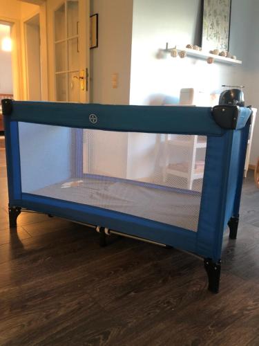 a blue bed in a room with a table at La belle vue in Born