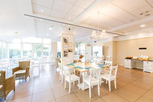 a dining room with a table and chairs at BeYou Hotel Villa Rosa in Riccione