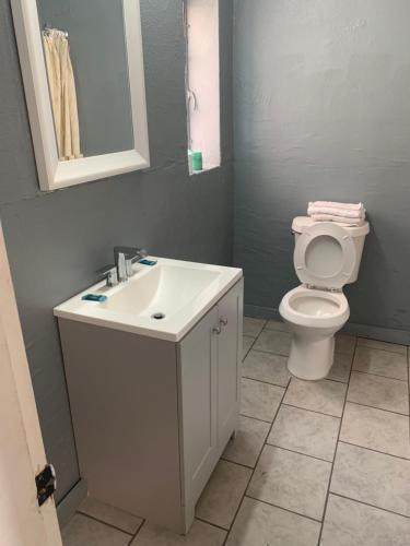 a bathroom with a white sink and a toilet at Economy Inn in Tupelo
