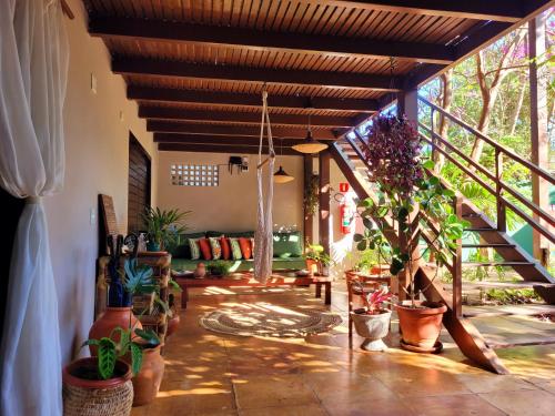 a patio with potted plants and a porch at Villa Valencia in Jericoacoara