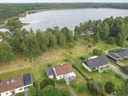 an aerial view of a house with a lake at Björkdahla in Dörarp