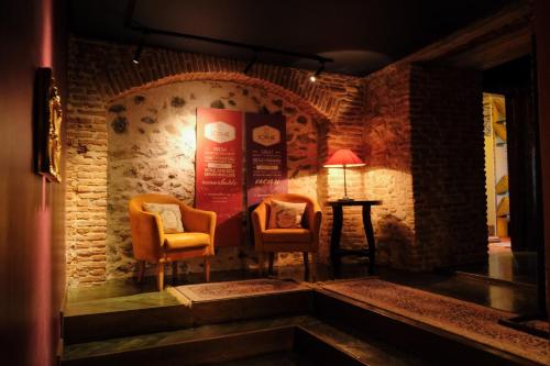 a room with two chairs and a sign on the wall at Bohemian Sophie Korce in Korçë