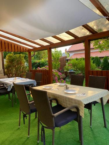 a table and chairs sitting under a pergola at Villa Lux in Hévíz
