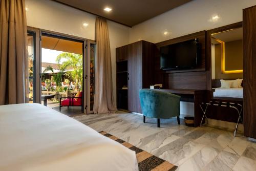 a hotel room with a bed and a desk and a television at The Lemonary Marrakech in Marrakech