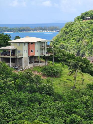 a house on top of a hill with trees at flamboyantvilla in Gros Islet