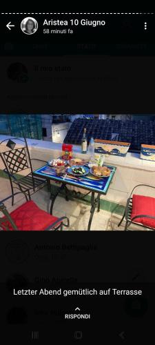 a page of a website with a table and chairs at Cala Di Luna House in Vietri sul Mare
