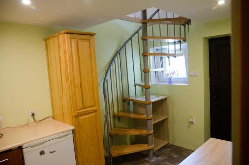 a spiral staircase in the corner of a room at Pod Dębami in Wadowice