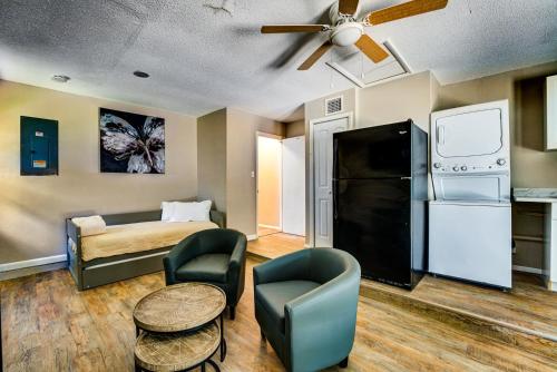a living room with a couch and a bed and a ceiling fan at Quiet Location Duplex House - Minutes Away from Everything - Winter Park, Florida in Orlando