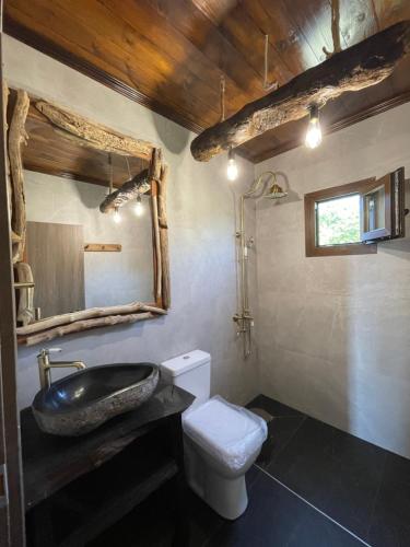 a bathroom with a sink and a toilet at Luxury Wooden Villas in Makrygialos