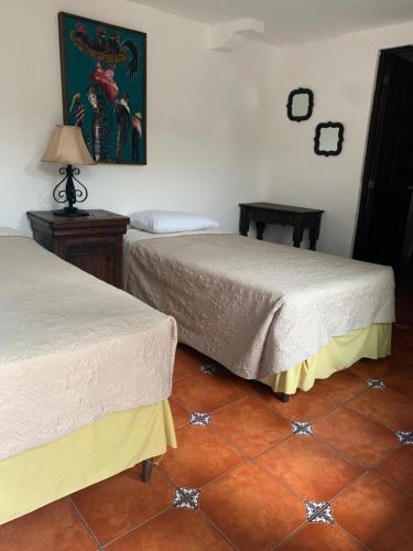 two beds sitting next to each other in a room at Posada El Antaño in Antigua Guatemala