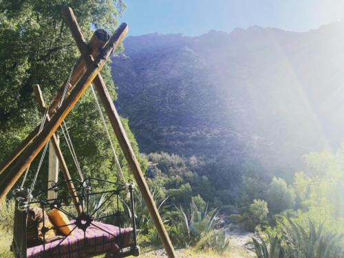 a ride on a hill with a view of a valley at Hotel Altiplanico Cajón del Maipo in San José de Maipo